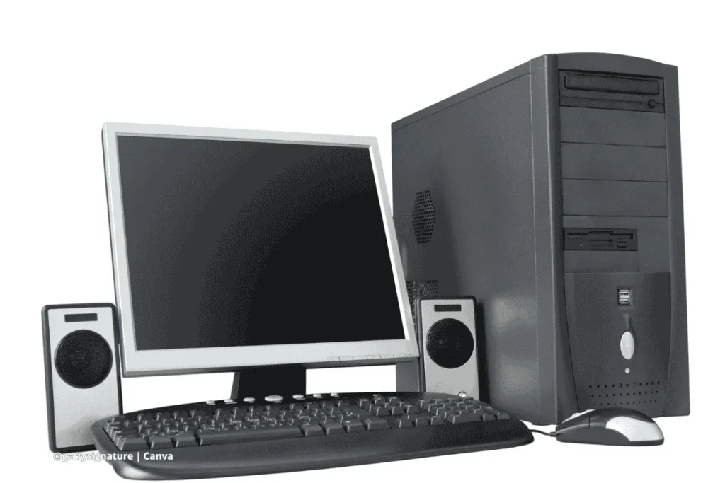 Computadora de escritorio con monitor, torre, teclado, mouse y altavoces